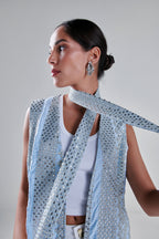 A model wearing a light blue sleeveless vest and matching scarf adorned with silver sequins, styled over a white ribbed tank top against a neutral gray background. #Baby Blue